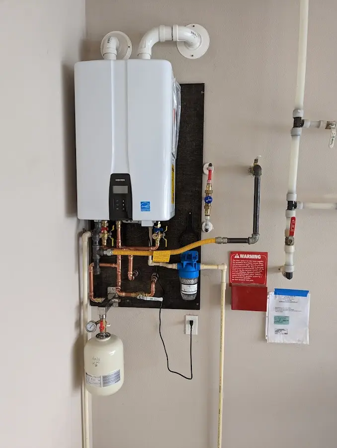 Professional plumber installing copper piping in a Port Allen home